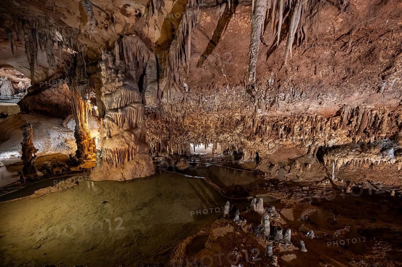 Stalactites and stalagmites, rock formations in a stalactite cave with water basin, Grotta del Fico, Gulf of Orosei, Baunei, Sardinia, Italy