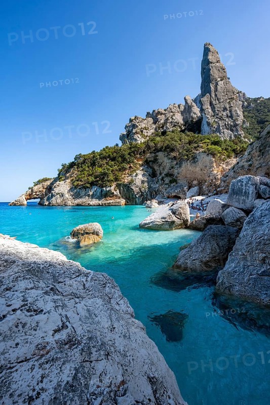 Light blue clear sea on a dream beach on Cala Goloritzé, picturesque rocky coast, steep coast with rock pin L'Aguglia, Golfo di Orosei, Baunei, Sardinia, Italy