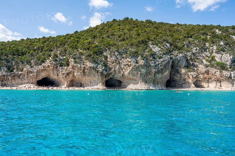 Clear blue water and picturesque rocky coast, Cala Luna cliffs and beach, Golfo di Orosei, Baunei, Sardinia, Italy