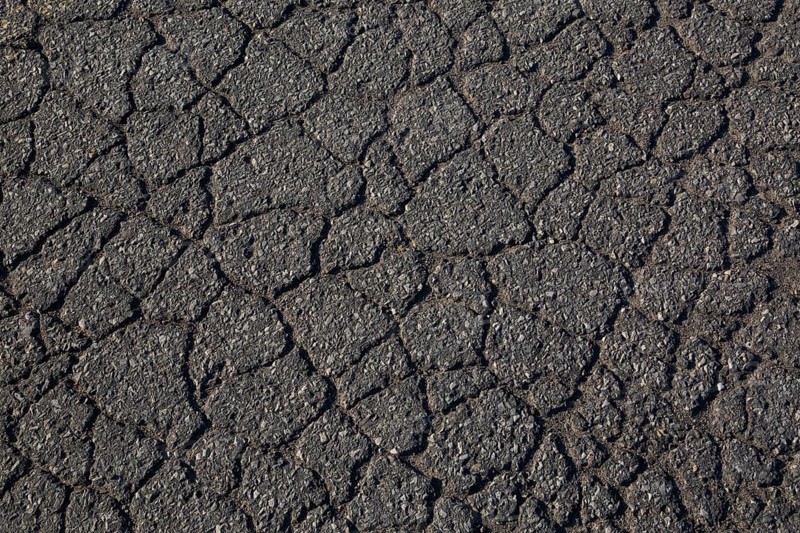 Top view and close-up of cracked asphalt road surface, Quebec, Canada