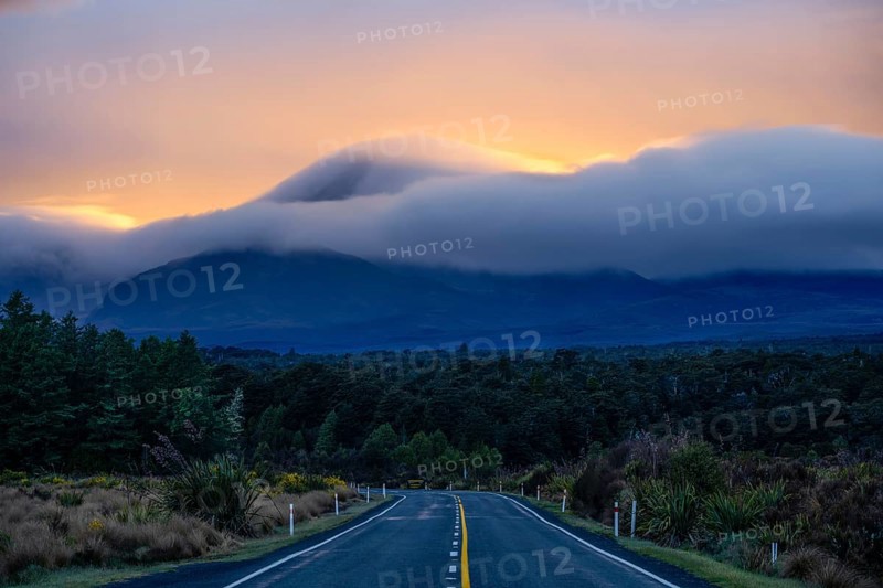 Mount Ngauruhoe in the morning at sunrise with glowing clouds, road SH 47. Tongariro National Park, North Island, New Zealand