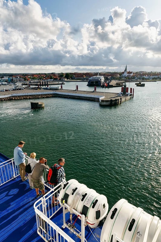 Tourists on the ferry to Rügen, ferry terminal, harbor with cityscape, St. Nicholas Church, dramatic cloudy sky, sunshine, Rønne, Rönne, Bornholm, Baltic Sea, Denmark