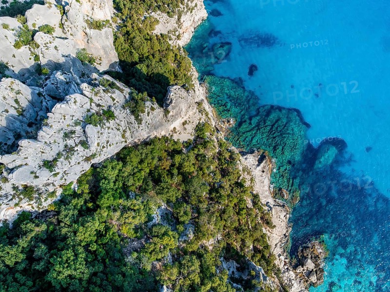 Picturesque rocky coast, blue sea at Cala Goloritzé, top-down, aerial view, Golfo di Orosei, Baunei, Sardinia, Italy