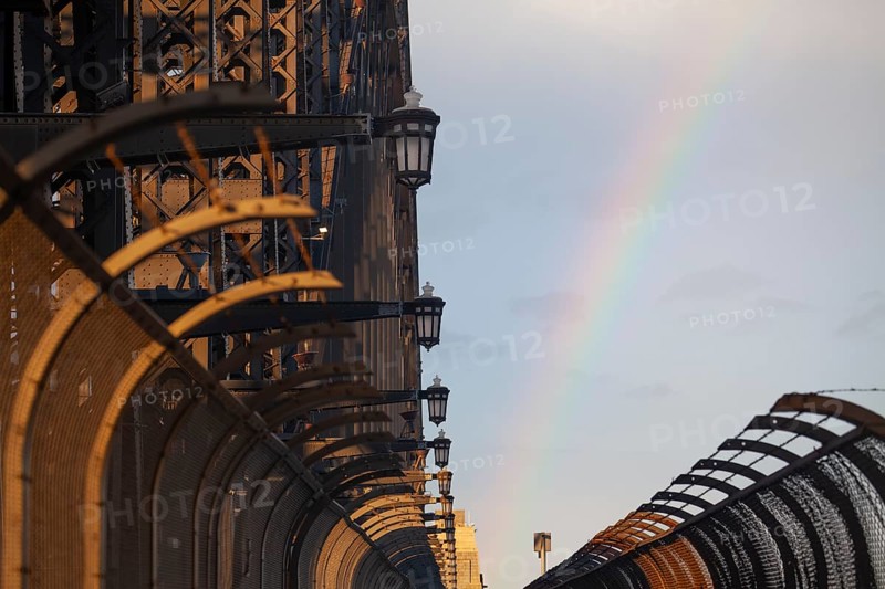 Details of the famous Sydney Harbour Bridge in the evening light with a rainbow