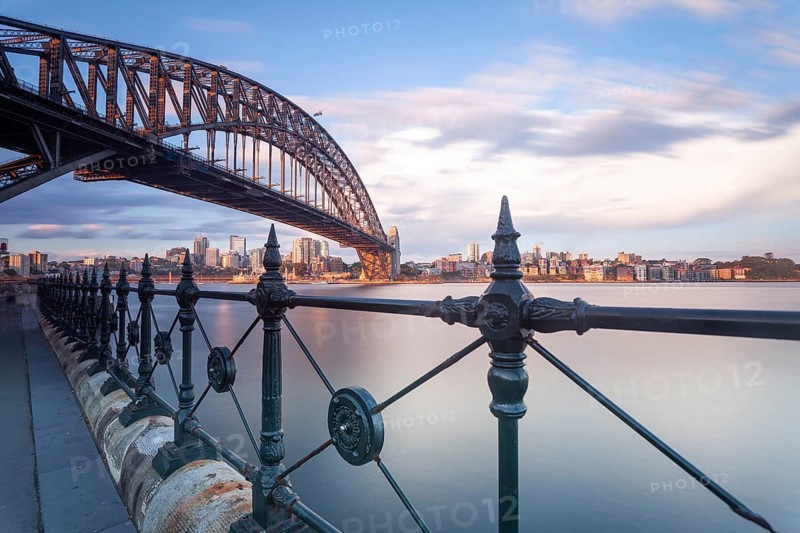 The Sydney Harbour Bridge and CBD skyscrapers in the evening light. View of Sydney's Central Business District from Kirribilli at dusk. New South Wales, Australia