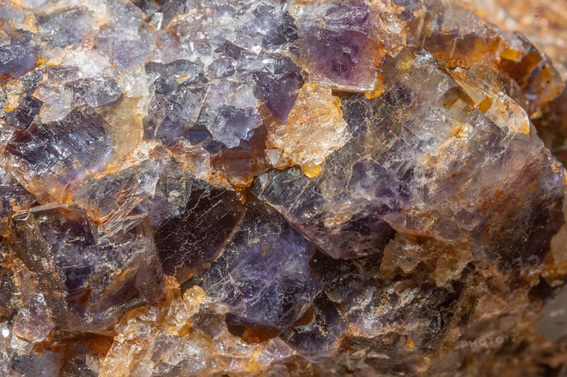 This scene shows a large rock fragment that contains quartz and fluorite crystals. Reflections and colors of minerals attract attention in the natural environment
