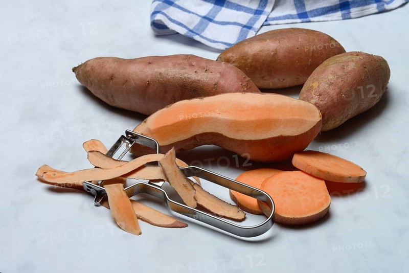 Sweet potatoes with potato peeler, Ipomoea batatas