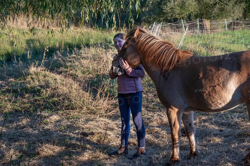 Young girl with her horse in the pasture, Othenstorf, Mecklenburg-Vorpommern, Germany