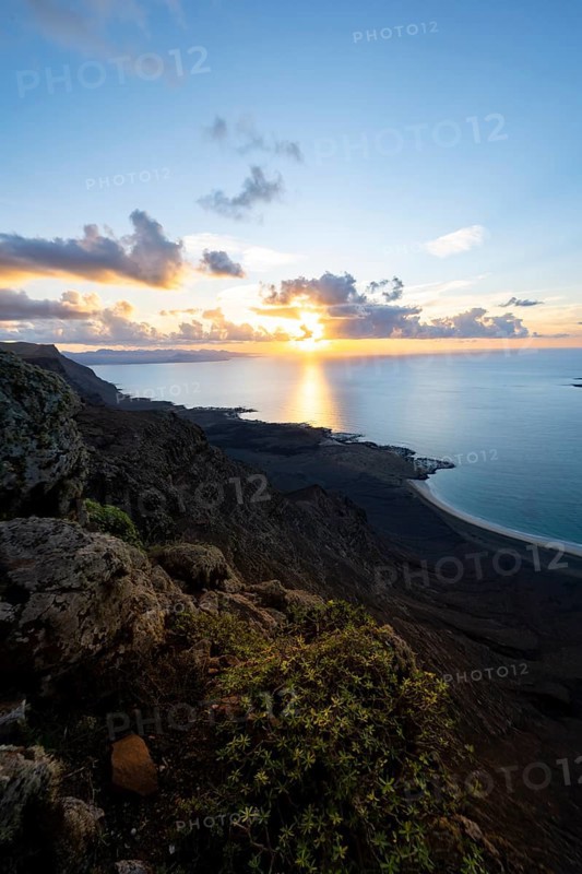 View of steep cliffs on sea and coast, Mirador del Porrito viewpoint at sunset, Lanzarote, Canary Islands, Spain
