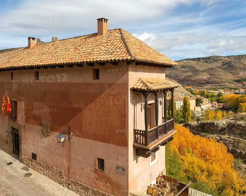 Alberque hostel building with flags flying, historic buildings in medieval village of Albarracín, Teruel province, Aragon, Spain