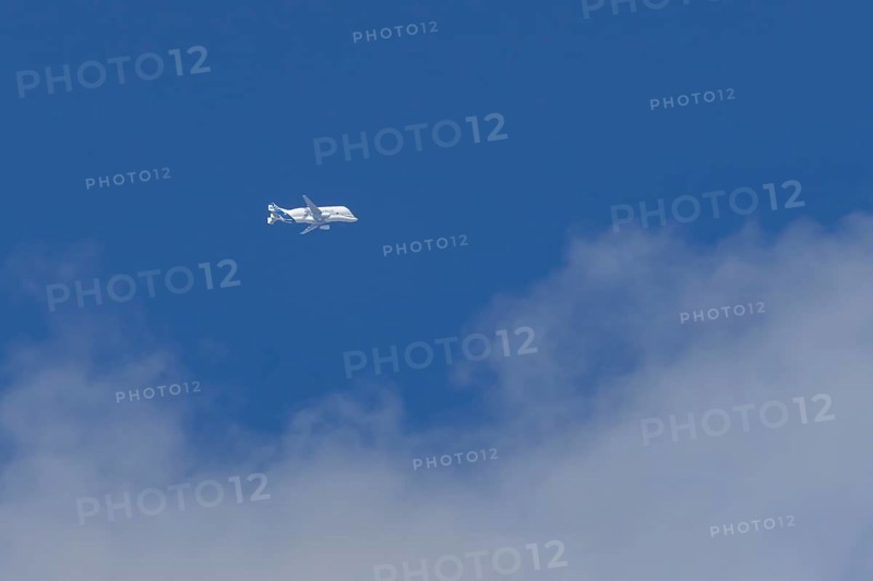 Airbus A330-743L Beluga XL cargo jet aircraft flying in a blue sky with white clouds, England, United Kingdom