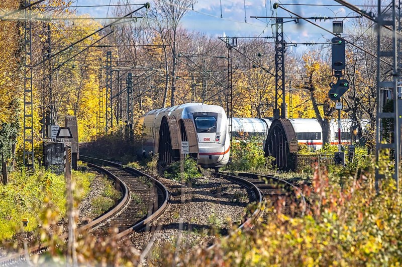 Intercity Express ICE. Open-route passenger train in the Stuttgart North Station area. Arched bridge and landscape in autumn. Stuttgart, Baden-Württemberg, Germany