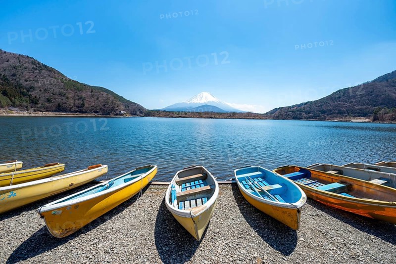Rowing boats on shore, view across the lake to Mt Fuji volcano, Motosu Lake, Yamanashi Prefecture, Japan