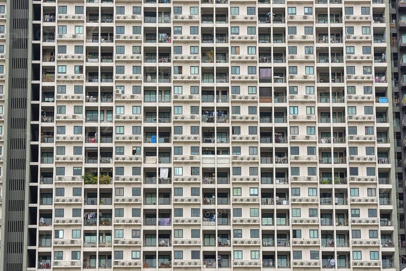 Exterior façade of a residential high-rise building of Condo U (a brand or series name of the Thai real estate developer Grand Unity Development Co., Ltd. (often abbreviated Grand U), Bangkok Yai district, the old town of Bangkok, Thailand