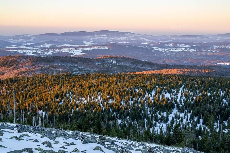 View from Mount Lusen over the hills of the bavarian forest at sunrise in winter, Bavaria, Germany