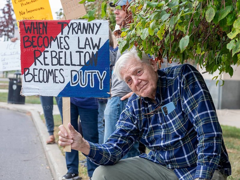 Detroit, Michigan USA - 18 October 2025 - Protesters from Detroit and Grosse Pointe gathered on the border between their cities for a 'No Kings' rally, protesting President Trump's actions against immigrants and against democratic institutions