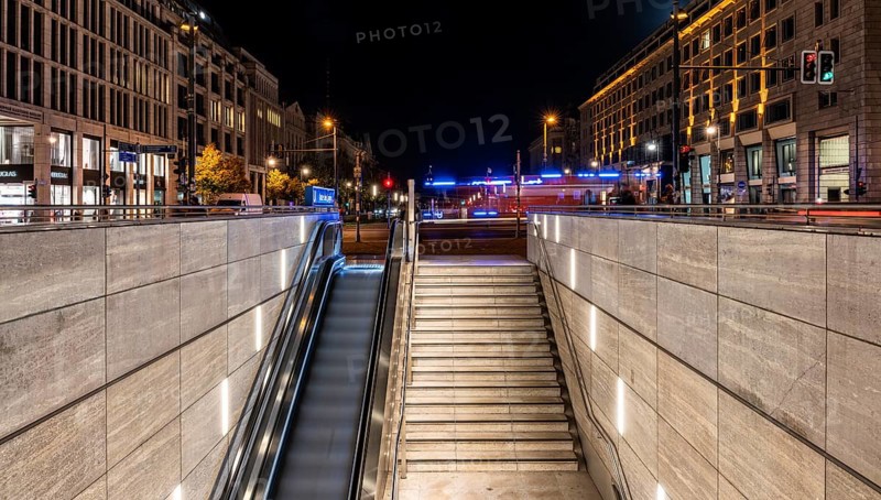 Night photo, long exposure with motion blur, modern underground entrance at Unter den Linden station, contemporary design with stairs and escalator, Berlin, Germany