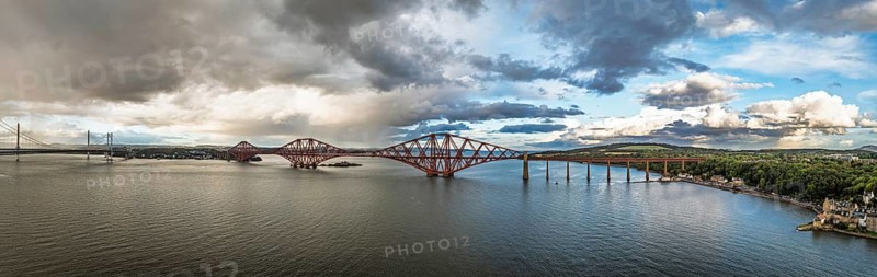 Sunset Panorama of Rain clouds over Forth Bridge from a drone, Queensferry Crossing, Forth Estuary, Scotland, United Kingdom