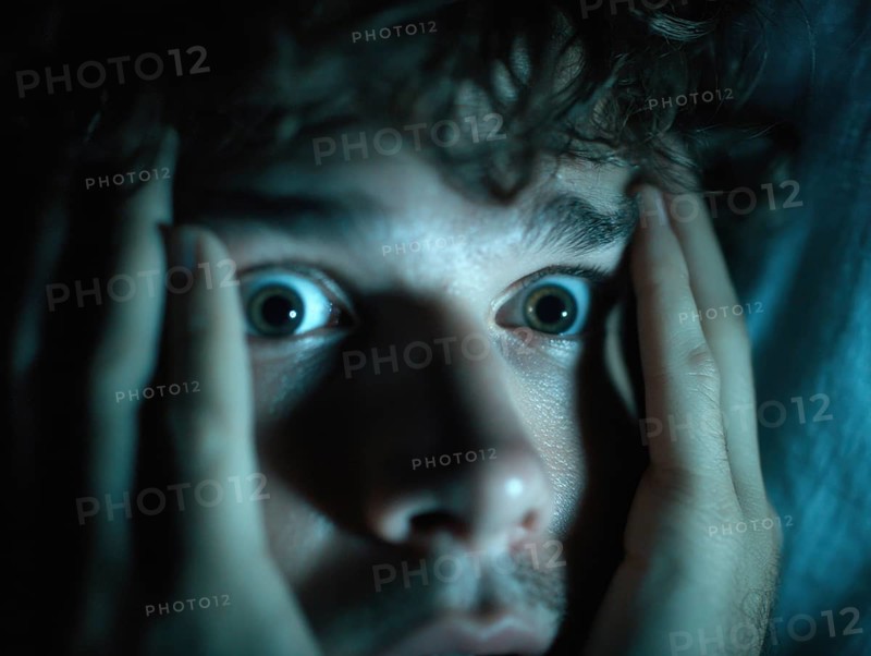 A close-up of a man whose face is marked by fear, symbolising anxiety disorders, panic attacks, mental illness, AI generated, AI generated