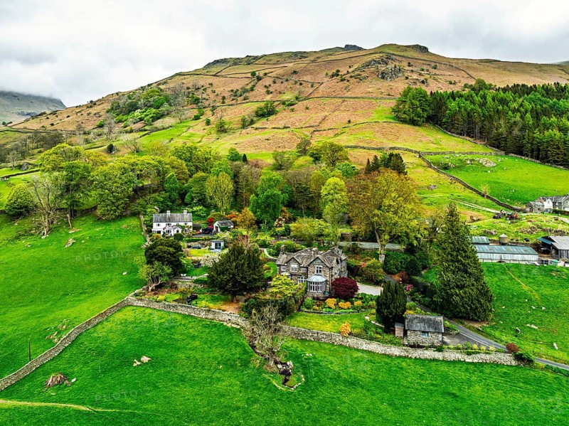 Farms and Mountains over road A591 from a drone, Grasmere Lake, Grasmere, Ambleside, Lake District, Westmorland, Cumbria, UK