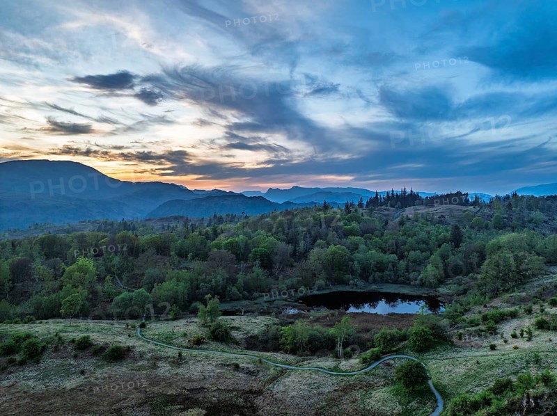 Sunset over Mountains and Coniston Water from drone, Lake District National Park, Cumbria, England, United Kingdom