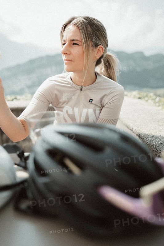 Young woman riding a racing bike on Lake Garda. Sunny weather and dolce vita