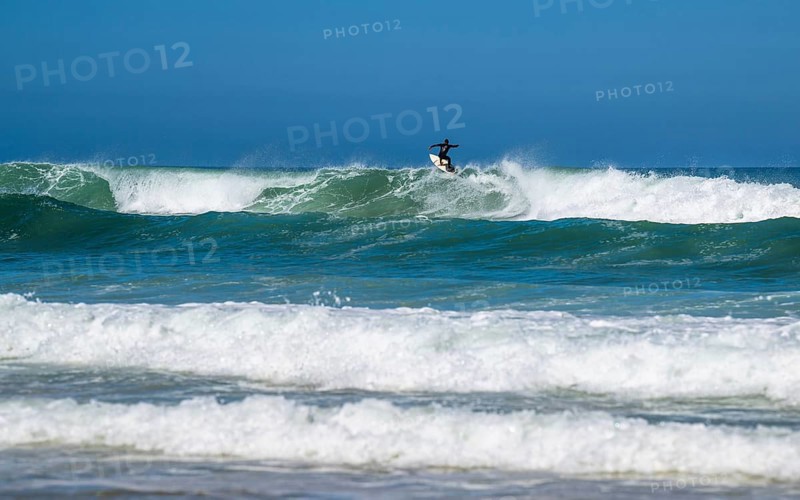 Surfer riding a wave on Contis beach, Saint Julien en Born, Saint-Julien-en-Born, Landes, France