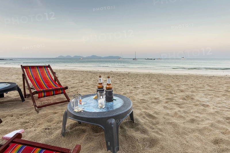 Abandoned deckchairs and parasol after sunset at Charlie Beach, Koh Mook Island, Andaman Sea, Thailand, Southeast Asia