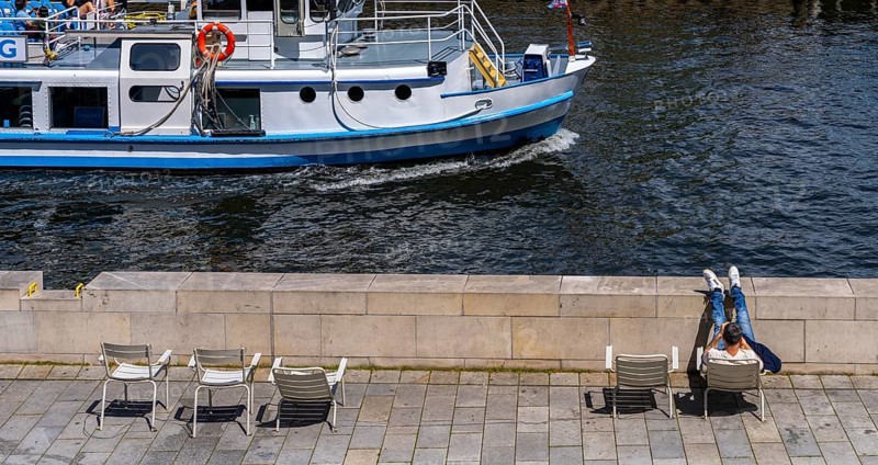 Promenade with chairs on the banks of the Spree from the Humboldt Forum, Berlin, Germany