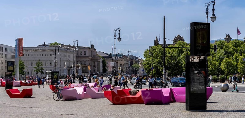Colourful seating elements on the open space in front of the entrance to the Humboldt Forum, Berlin, Germany