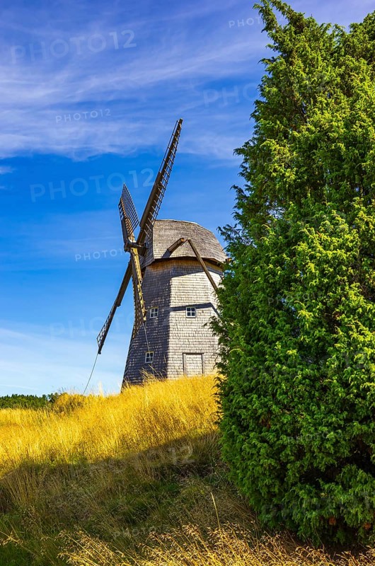 Historic windmill in an epic summer landscape near the burial ground of Stenhusbacken and the village of Sunnersberg near Lidköping, Västergötland, Västra Götalands län, Sweden