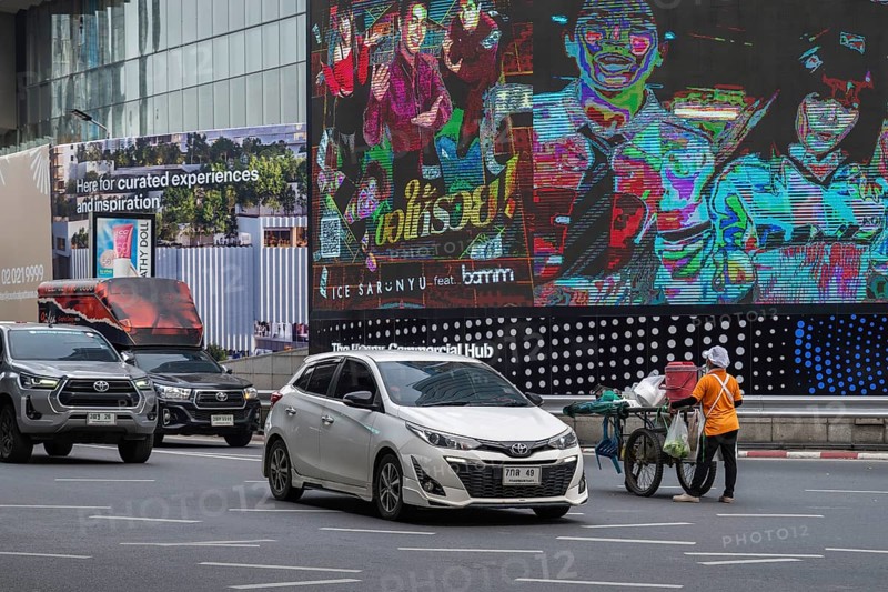 Street crossing woman with cookshop, Bangkok, Thailand
