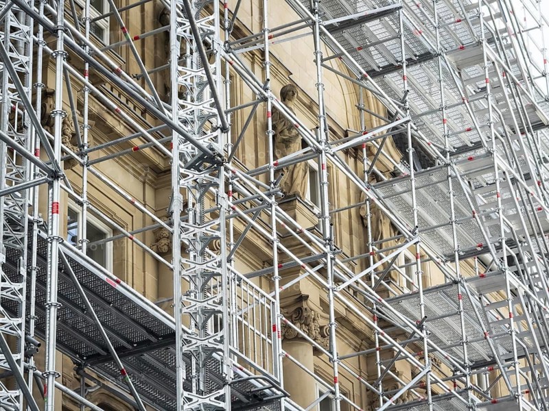 Scaffolded façade of the district court with metal platforms and stairs in Wuppertal, Germany