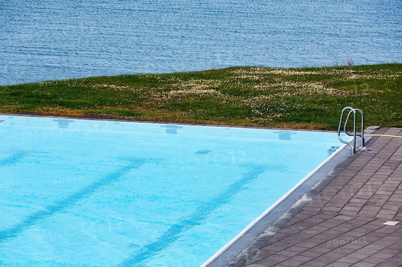 View from above of swimming pool by the sea, thermal bath, heated outdoor pool in Hofsos at the fjord Skagafjördur, Lake Greenland, Hofsos, Tröllaskagi peninsula, Nordurland vestra, North Iceland, Iceland