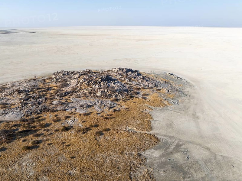 Rocky island with baobab trees in a dry salt pan, aerial view, Kubu Island, Botswana