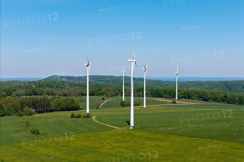 Row of wind generators on an undulating landscape with clear sky, Swabian Alb, Baden-Württemberg, Germany