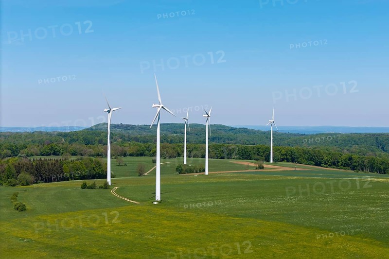 Several wind turbines on extensive meadows with forest in the background, Swabian Alb, Baden-Württemberg, Germany
