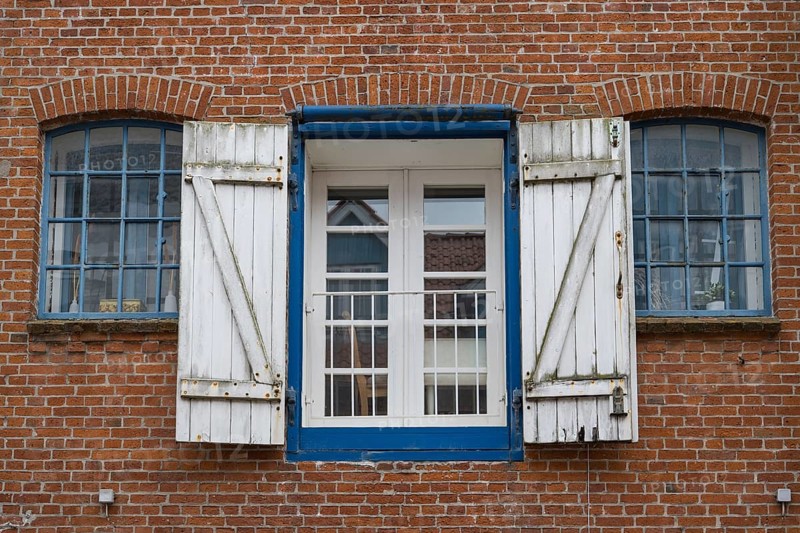 Window with shutters, brick façade, warehouse building, old town centre, Husum, North Frisia, Schleswig-Holstein, Germany