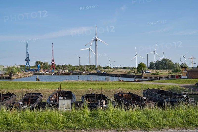 Old barges, shipyard, wind turbines, Dockkoog, Husum, North Frisia, Schleswig-Holstein, Germany