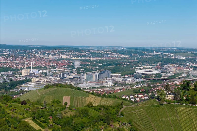 Panoramic view over the city of Stuttgart with vineyards in the foreground, in the background the Mercedes-Benz plant in Stuttgart-Untertürkheim and the MHP Arena, Baden-Württemberg, Germany