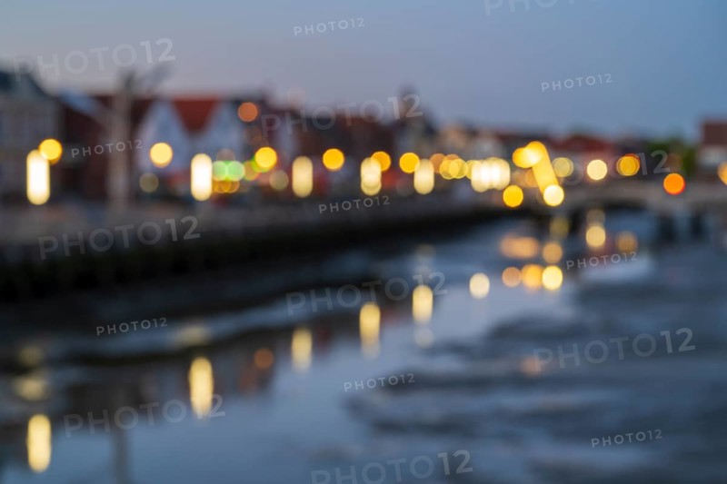 Buildings at the harbour, skyline, illuminated, blue hour, blurred, Husum, North Sea, North Frisia, Schleswig-Holstein, Germany