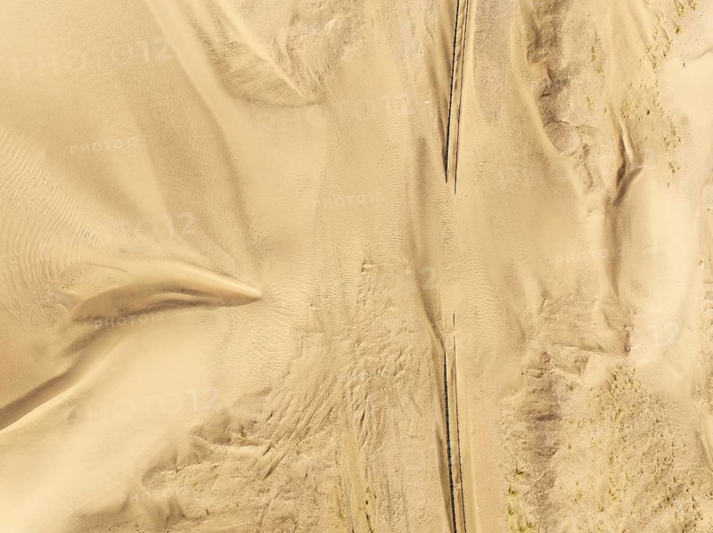 Rails covered with sand in the southern Namib Desert. Aerial view. Drone shot. Namibia