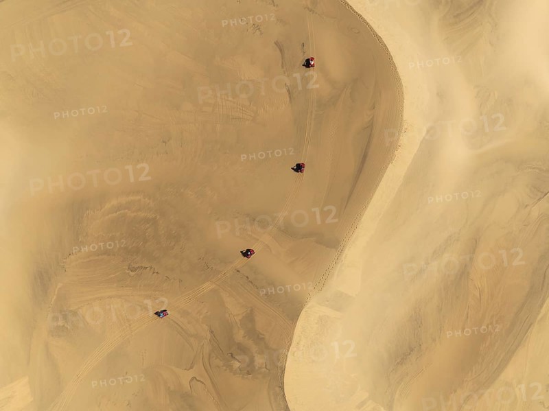 Quad bikes in the dunes of the Namib Desert in the vicinity of the coastal town of Swakopmund. Aerial view. Drone shot. Namibia