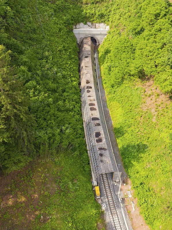 View from above of a railway tunnel surrounded by dense forests, construction of the Hermann Hesse Railway, Calw, Germany