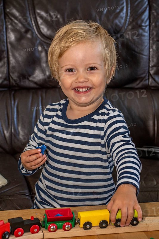 Blond boy, 2 years old, playing with toy train in Ystad, Skåne County, Sweden, Scandinavia