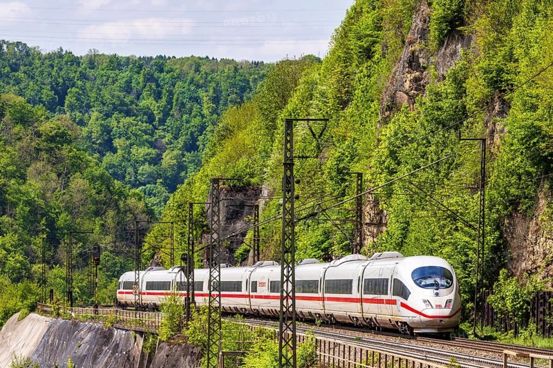 InterCityExpress ICE en route on the winding railway line of the Geislinger Steige. Landscape on the railway's Filstalline line in spring. Amstetten, Baden-Württemberg, Germany