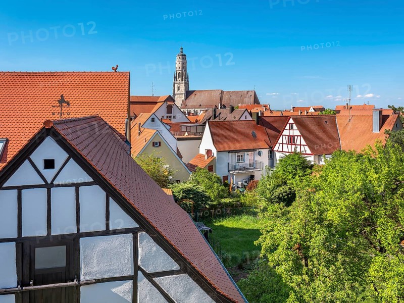 View from the medieval town wall over the houses of the historic old town to the tower of St George's Church, called Daniel, Nördlingen, Bavaria, Germany
