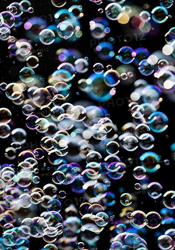 Many, small iridescent and floating soap bubbles against a black background, Recklinghausen, North Rhine-Westphalia, Germany