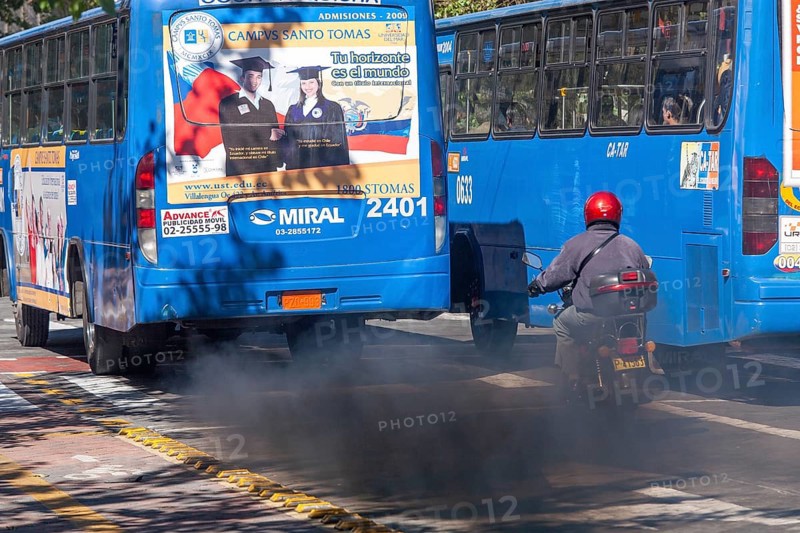 Buses in motion emitting pollution, City of Quito. Pichincha province, Ecuador, South America