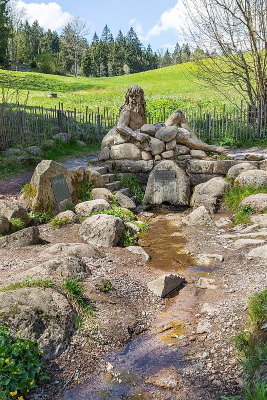 Figure of the river god Danuvius by sculptor Wolfgang Eckert at the source of the Breg, source of the Danube in Furtwangen in the Black Forest, Baden-Württemberg, Germany